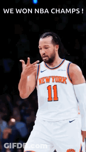 A Basketball Player For The New York Knicks Is Standing On The Court . GIF
