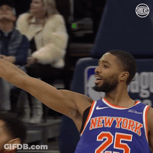 A Basketball Player For The New York Knicks Reaches Up GIF