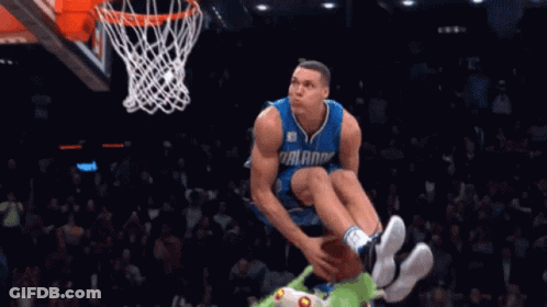 A Basketball Player For The Orlando Magic Is Jumping In The Air With The Ball GIF