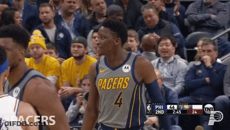 A Basketball Player For The Pacers Is Standing In Front Of A Crowd GIF
