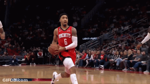 A Basketball Player For The Rockets Dribbles The Ball On The Court GIF