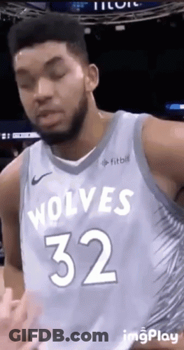 A Basketball Player For The Wolves Is Wearing A Blue Jersey With The Number 32 On It . GIF