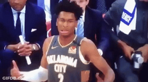 A Basketball Player From Oklahoma City Is Giving A Thumbs Up While Sitting In The Stands During A Game . GIF