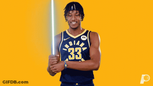 A Basketball Player From The Indiana Pacers Holds A Light Saber GIF
