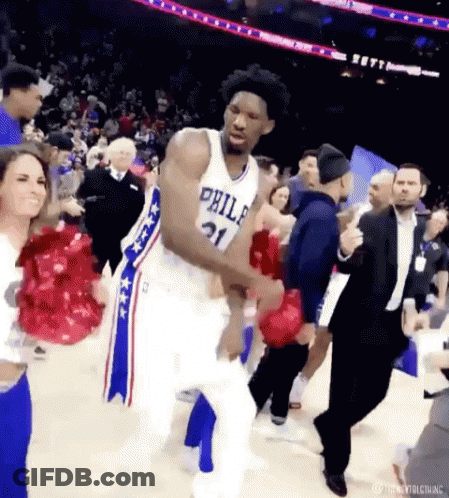A Basketball Player From The Philadelphia 76Ers Is Dancing On The Court With Fans . GIF