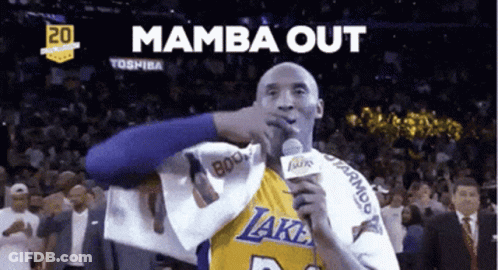 A Basketball Player Holding A Microphone With The Words " Mamba Out " Behind Him GIF