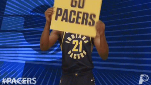 A Basketball Player Holds A Sign That Says Go Pacers GIF
