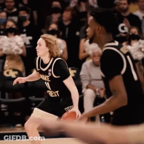 A Basketball Player In A Black Jersey With The Number 11 On It Is Dribbling The Basketball . GIF