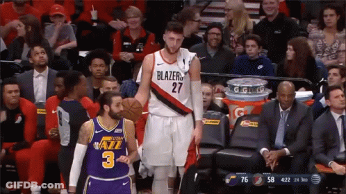 A Basketball Player In A Blazers Jersey Stands Next To Another Player In A Jazz Jersey GIF