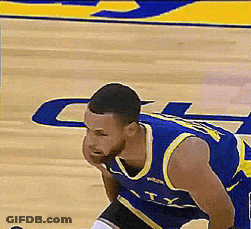 A Basketball Player In A Blue And Yellow Uniform Is Kneeling On The Court . GIF