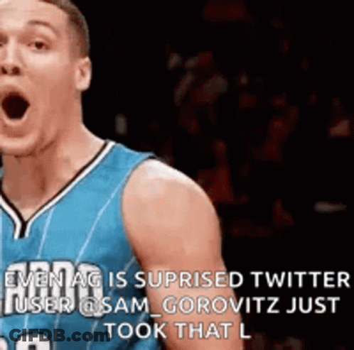 A Basketball Player In A Blue Jersey Is Making A Funny Face While Standing On The Court . GIF