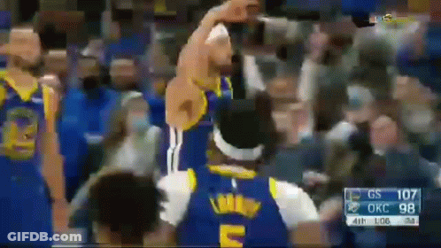 A Basketball Player In A Blue Jersey With The Letter E On It Is Standing In Front Of A Crowd . GIF