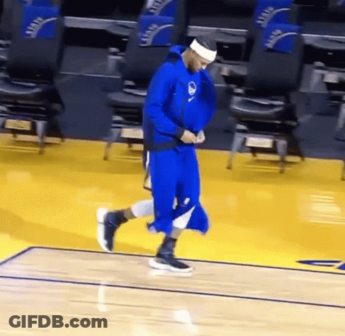 A Basketball Player In A Blue Uniform Is Walking On The Court . GIF