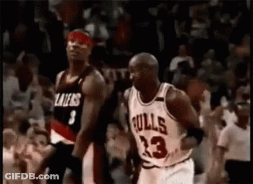 A Basketball Player In A Bulls Jersey Is Dribbling A Basketball While Another Player In A Lakers Jersey Watches . GIF