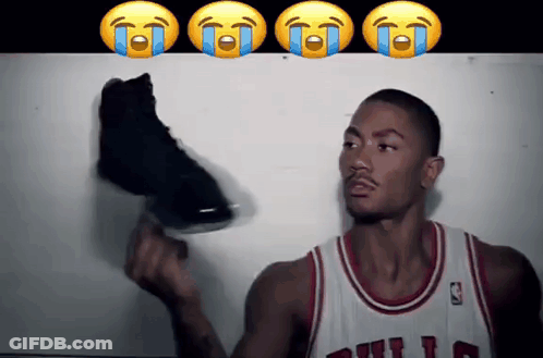 A Basketball Player In A Bulls Jersey Is Holding A Shoe GIF