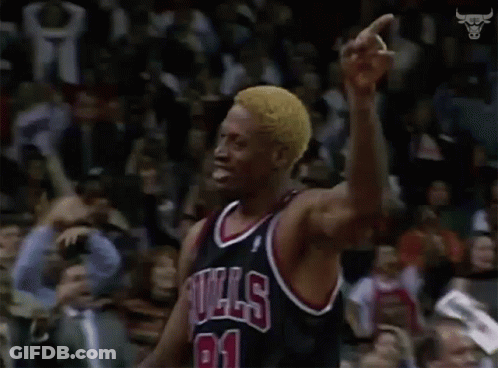 A Basketball Player In A Bulls Jersey Is Pointing At The Crowd . GIF