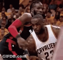A Basketball Player In A Cavaliers Jersey Is Fighting Another Player . GIF
