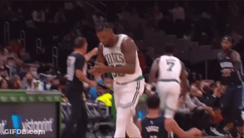 A Basketball Player In A Celtics Jersey Is Talking To A Referee During A Basketball Game . GIF