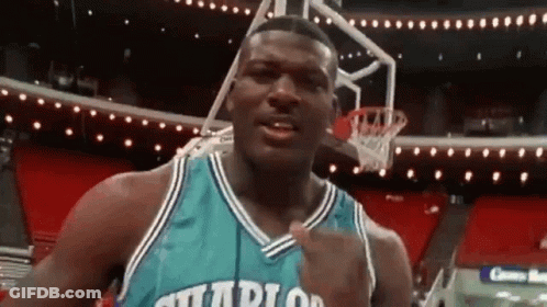 A Basketball Player In A Charlotte Hornets Jersey Is Standing In Front Of A Basketball Hoop . GIF