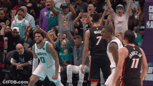 A Basketball Player In A Charlotte Jersey Stands In Front Of The Crowd GIF