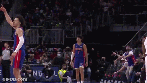 A Basketball Player In A Detroit Jersey Is Standing On The Court . GIF