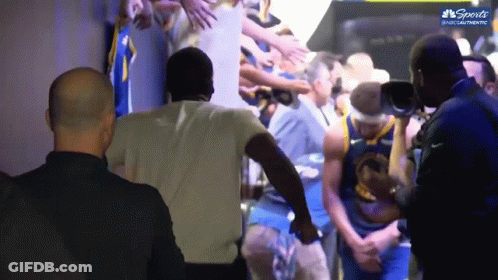 A Basketball Player In A Golden State Warriors Jersey Is Surrounded By Fans GIF