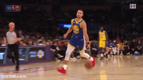 A Basketball Player In A Golden State Warriors Uniform Is Dribbling A Ball GIF