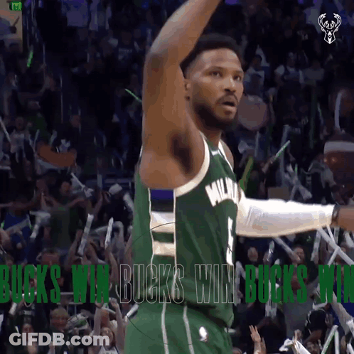 A Basketball Player In A Green Milwaukee Jersey Celebrates With Fans GIF