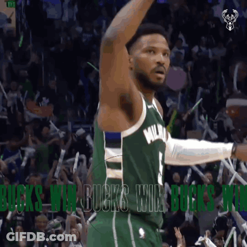 A Basketball Player In A Green Milwaukee Jersey Celebrates With Fans GIF
