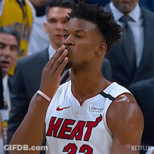 A Basketball Player In A Heat Jersey Is Blowing A Kiss . GIF