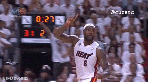 A Basketball Player In A Heat Jersey Is Giving A Thumbs Up In Front Of A Crowd Of People . GIF