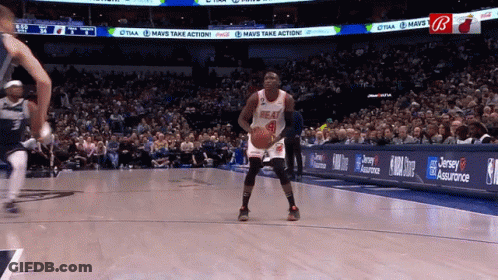 A Basketball Player In A Heat Jersey Stands On The Court GIF