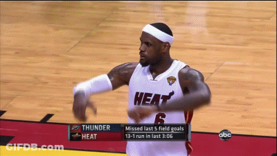 A Basketball Player In A Heat Uniform Is Dancing On The Court GIF