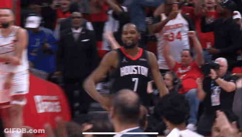A Basketball Player In A Houston Jersey Stands In Front Of A Crowd GIF