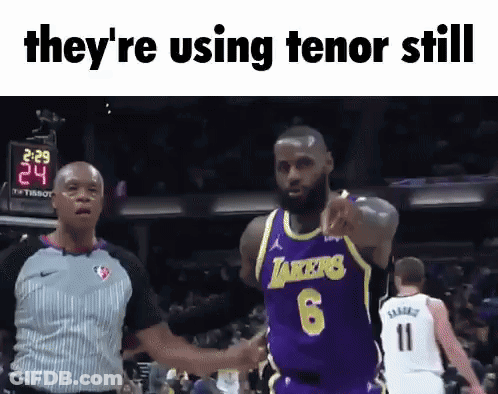 A Basketball Player In A Lakers Jersey Is Pointing At A Referee GIF