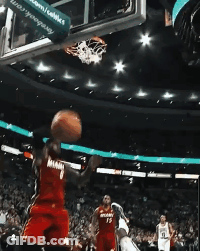 A Basketball Player In A Miami Jersey Is Going For A Dunk GIF