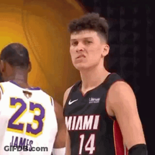 A Basketball Player In A Miami Jersey Is Standing Next To Another Player In A White Jersey . GIF