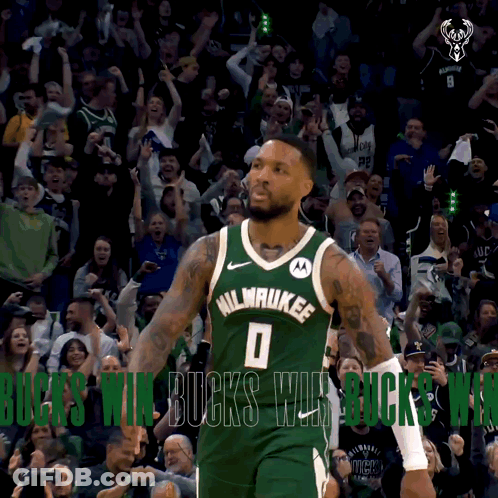A Basketball Player In A Milwaukee Jersey Stands In Front Of A Crowd GIF