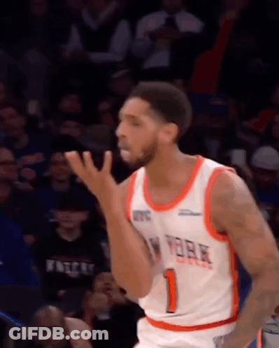 A Basketball Player In A New York Knicks Jersey Is Standing On The Court . GIF