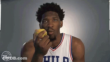 A Basketball Player In A Philadelphia 76Ers Uniform Is Eating A Lemon . GIF