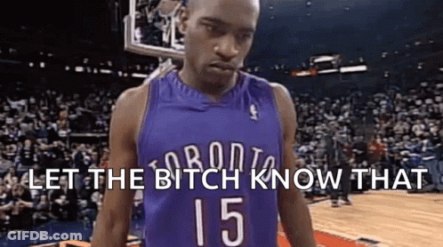 A Basketball Player In A Purple Jersey With The Number 15 On It Is Standing In Front Of A Crowd . GIF