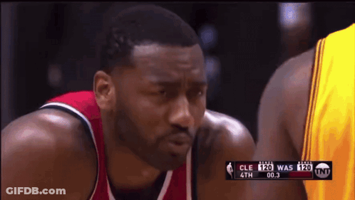 A Basketball Player In A Red And White Jersey Is Looking At Another Player In A Yellow Jersey GIF