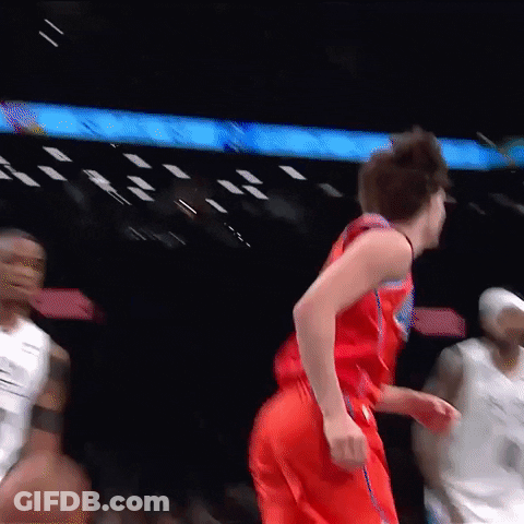 A Basketball Player In A Red Jersey Is Running On The Court . GIF