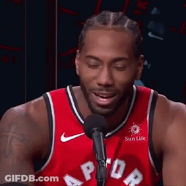 A Basketball Player In A Red Jersey Is Talking Into A Microphone . GIF