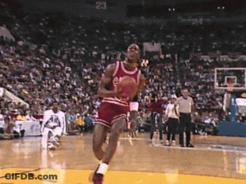 A Basketball Player In A Red Jersey With The Number 23 On The Back Jumps In The Air GIF