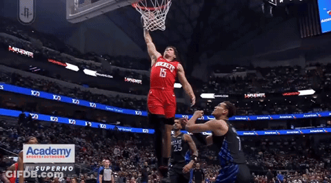 A Basketball Player In A Red Rockets Jersey Dribbles The Ball GIF