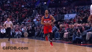A Basketball Player In A Red Uniform Is Dribbling The Ball GIF