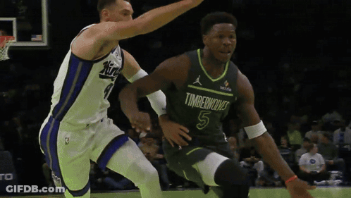 A Basketball Player In A Timberwolves Jersey Is Dribbling The Ball GIF