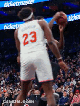 A Basketball Player In A White Jersey With The Number 23 On It Is Holding A Basketball In His Hand . GIF