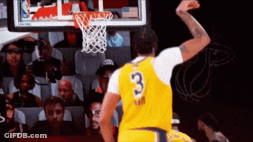 A Basketball Player In A Yellow Jersey With The Number 3 On It Is Jumping In The Air . GIF
